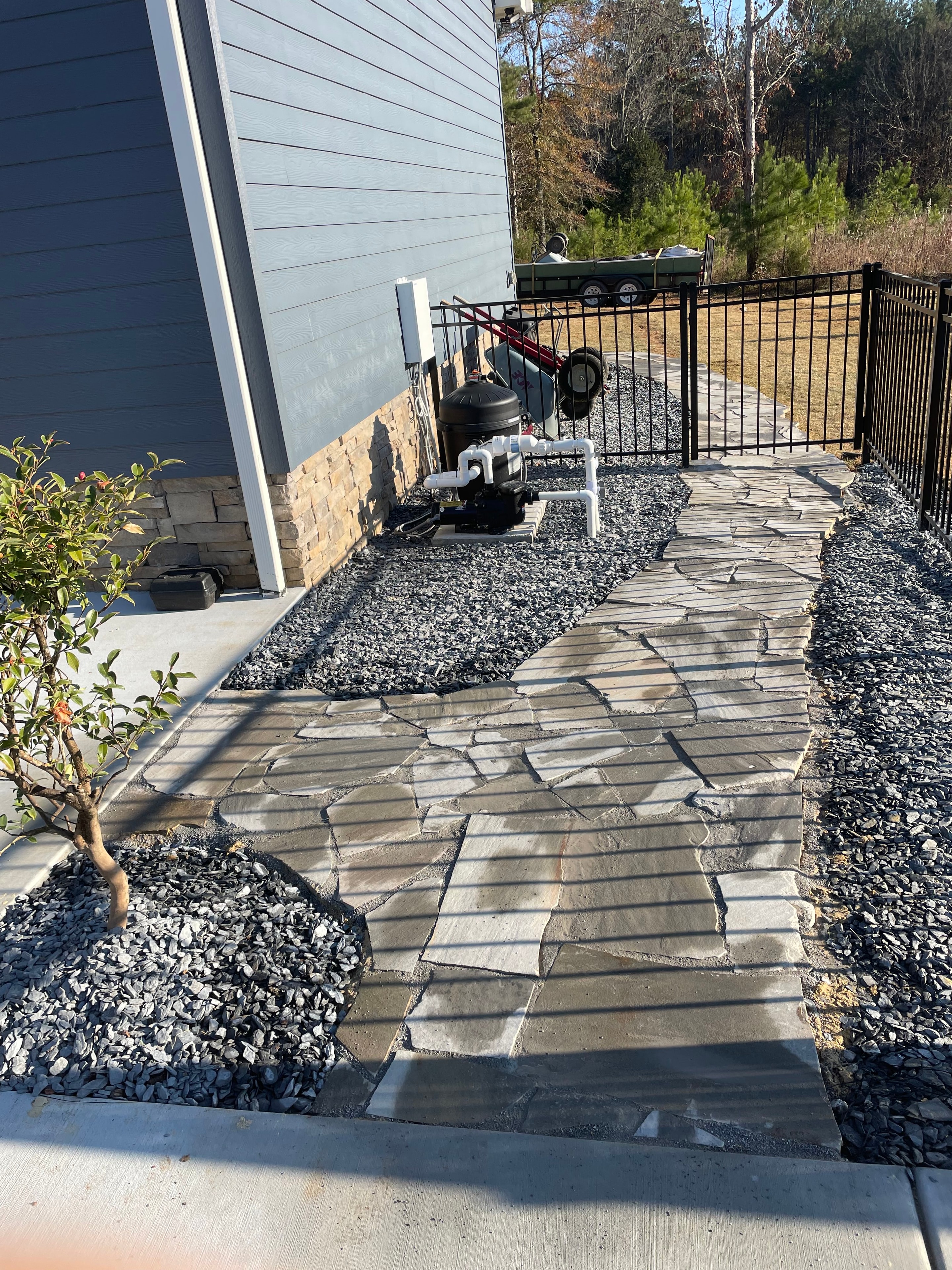 Stone veneer wall with drainage and paver patio