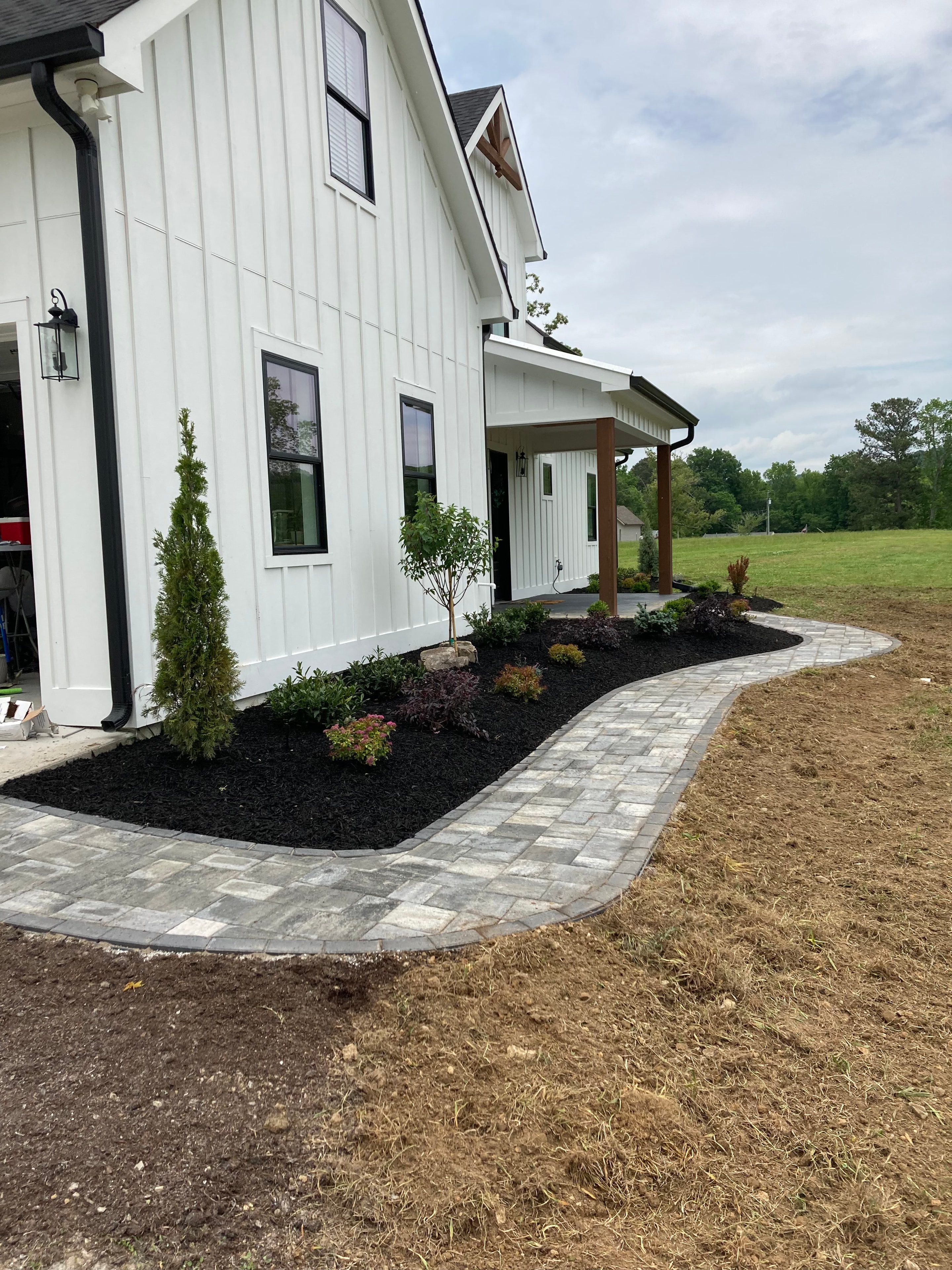 Curved block retaining wall with fresh plantings