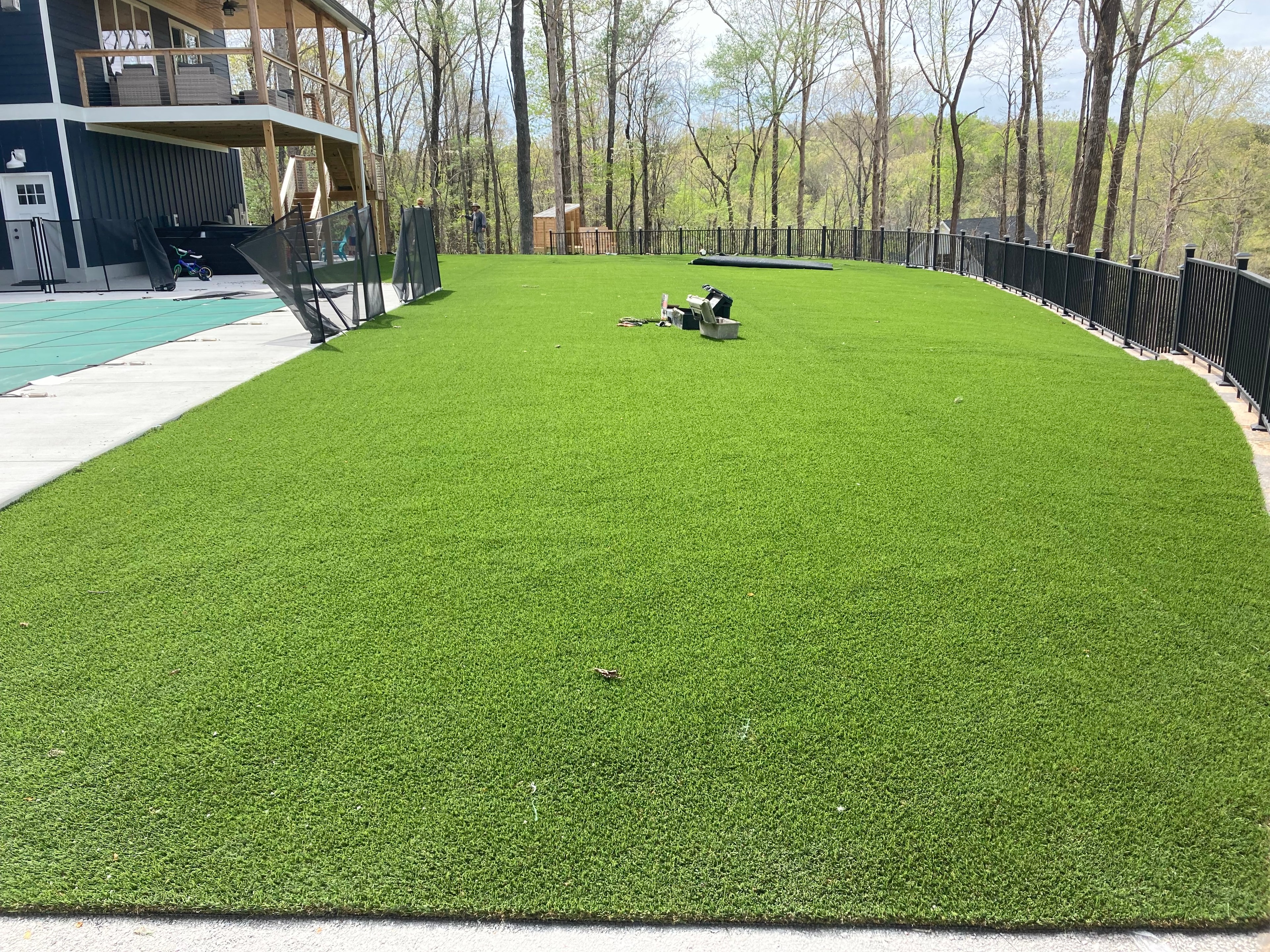 Aerial view of artificial turf installation on lakeside deck