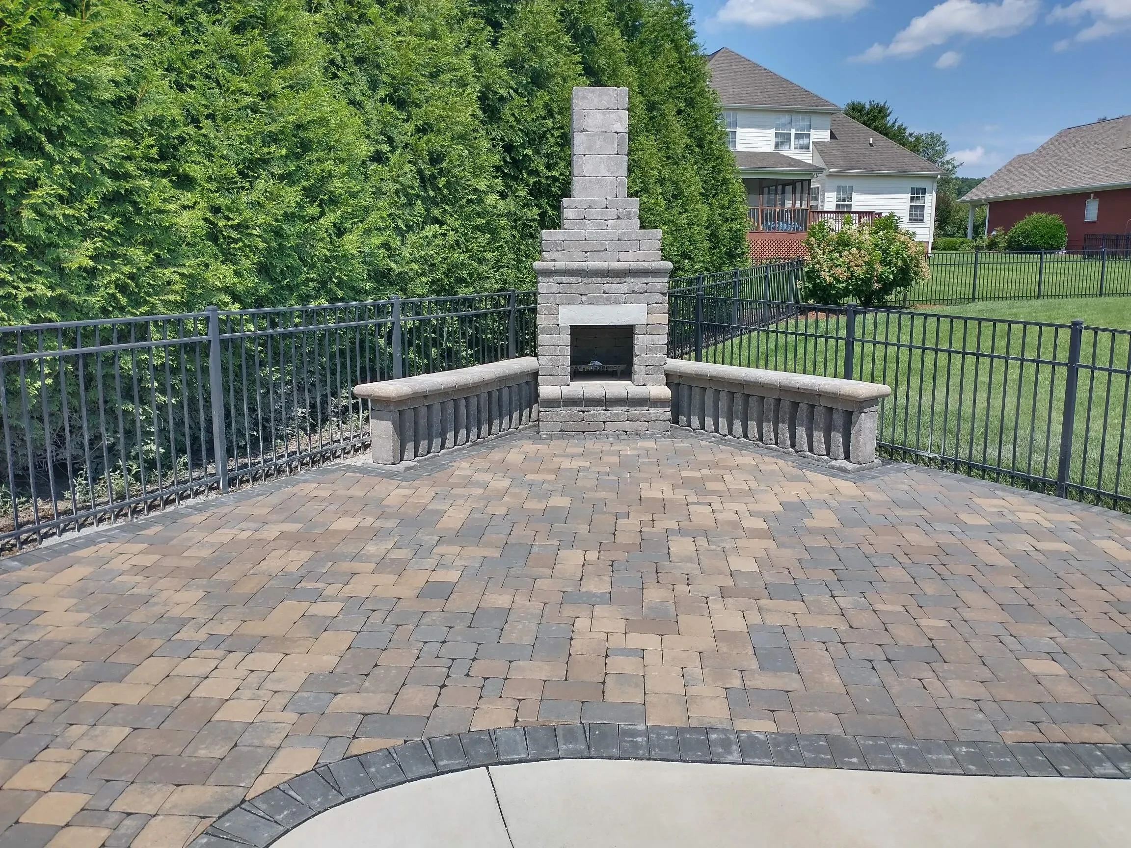 Outdoor patio with stone fireplace and seating