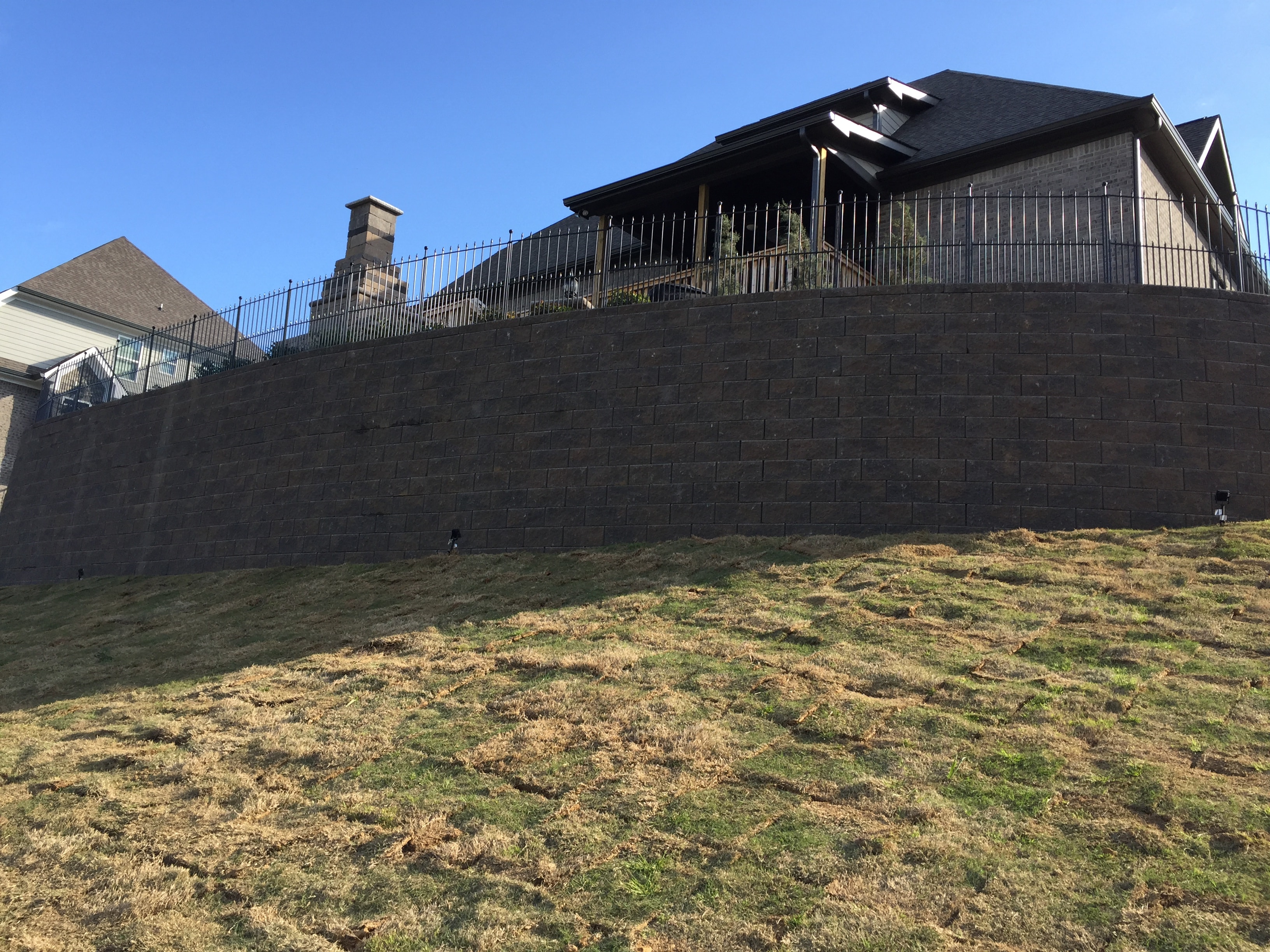 Large curved block retaining wall with deck